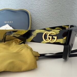 Gucci Black and Gold Sunglasses with Sleek Design